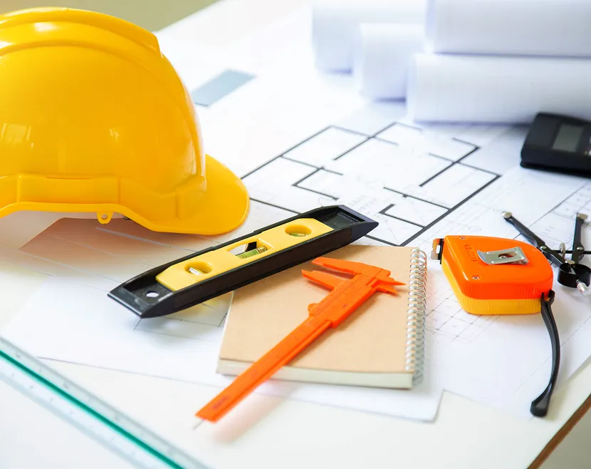 Construction tools on architectural blueprints.